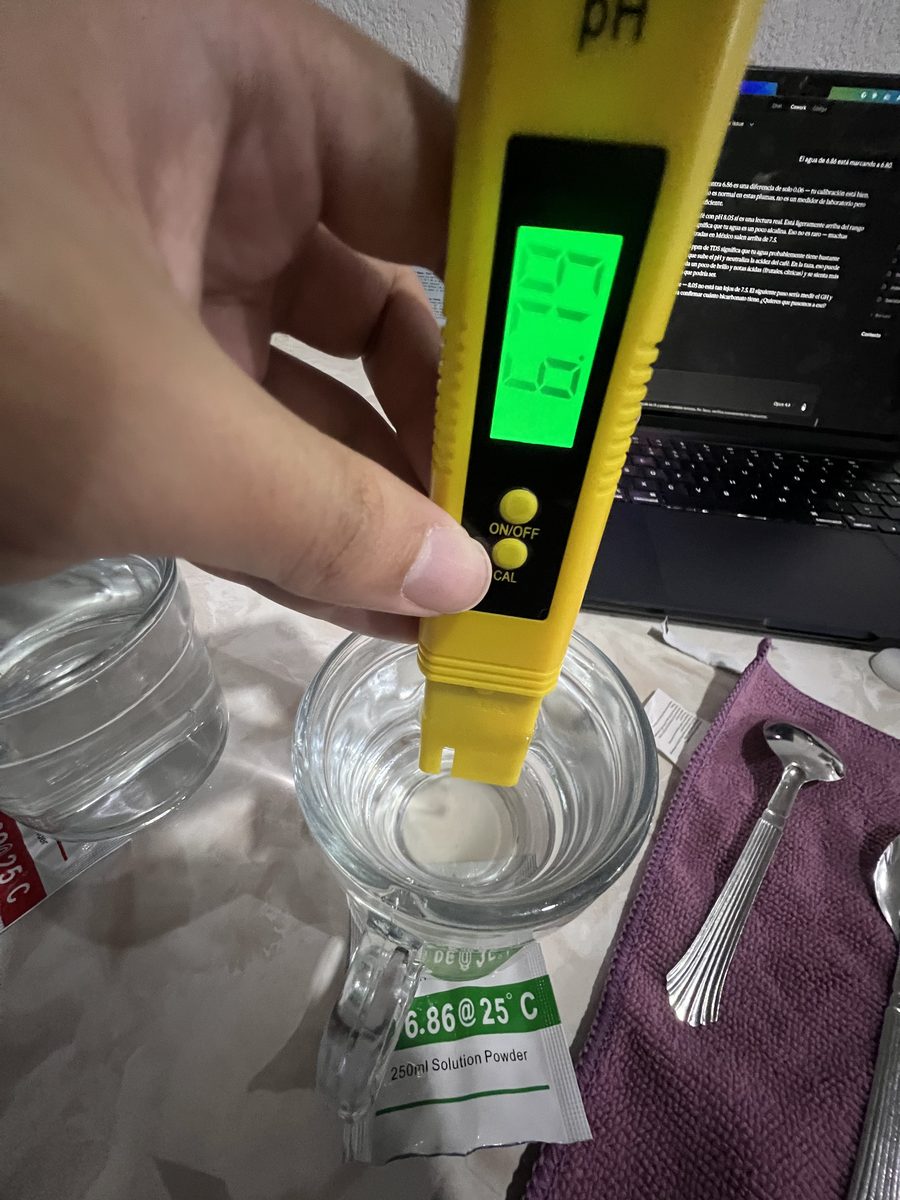 pH pen submerged in 6.86 buffer solution, showing reading on screen